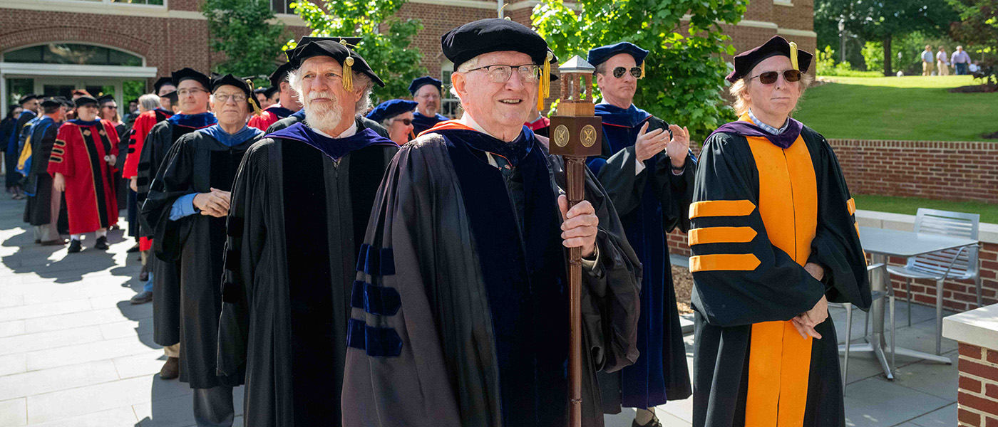 the faculty in regalia processing to graduation
