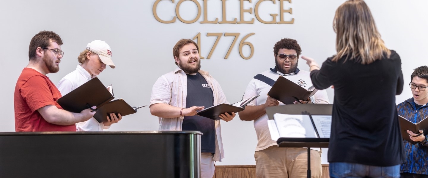 a professor directing the H-SC chorus music ensemble