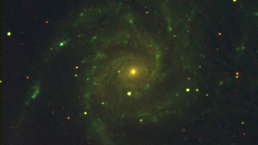 This is a three-color image of the Pinwheel Galaxy, a spiral galaxy much like our own. It was observed with the IR filter (shown as red), the G (green), and the H-α narrow band filter (blue).