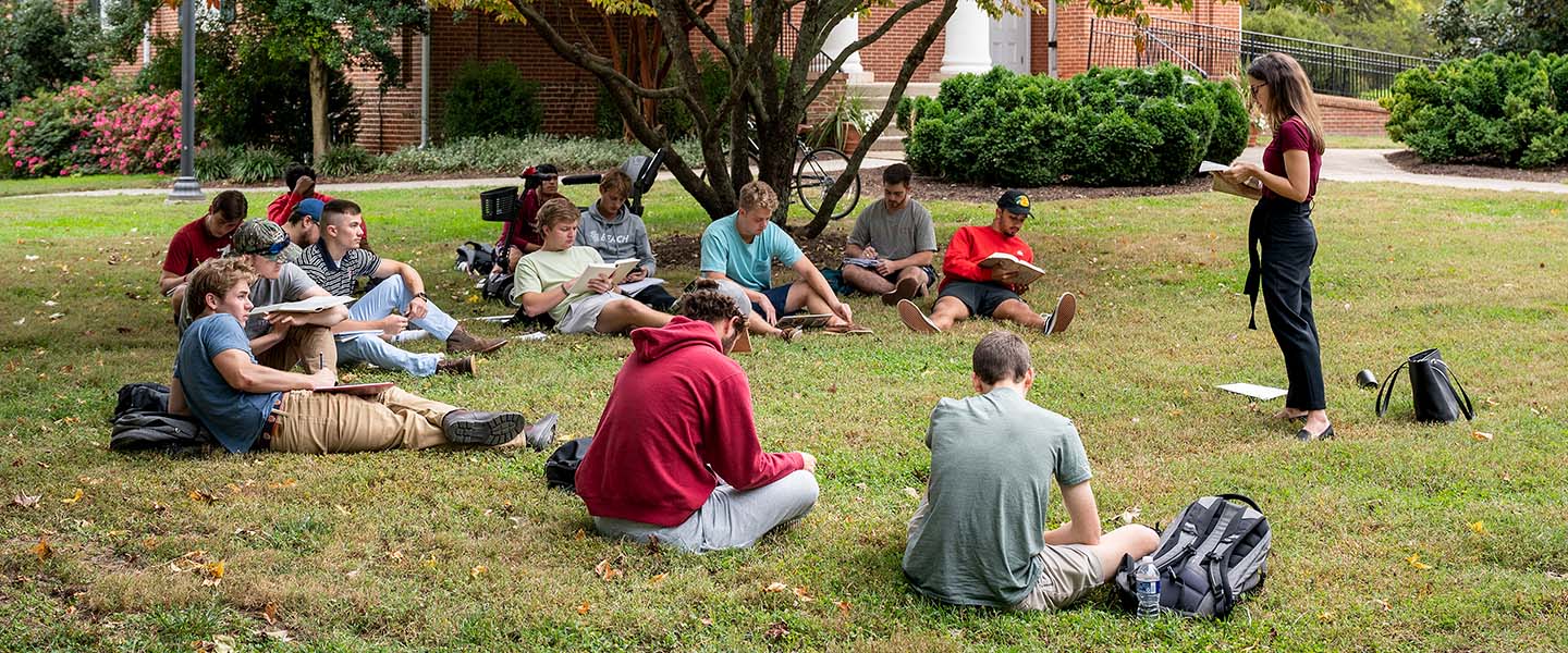a professor leading a class lecture outside