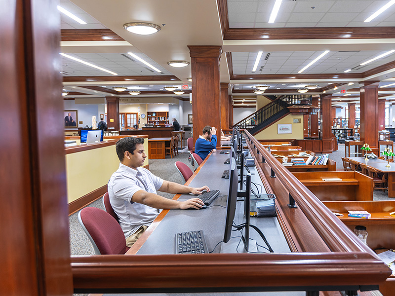 students sitting at computers in the library 