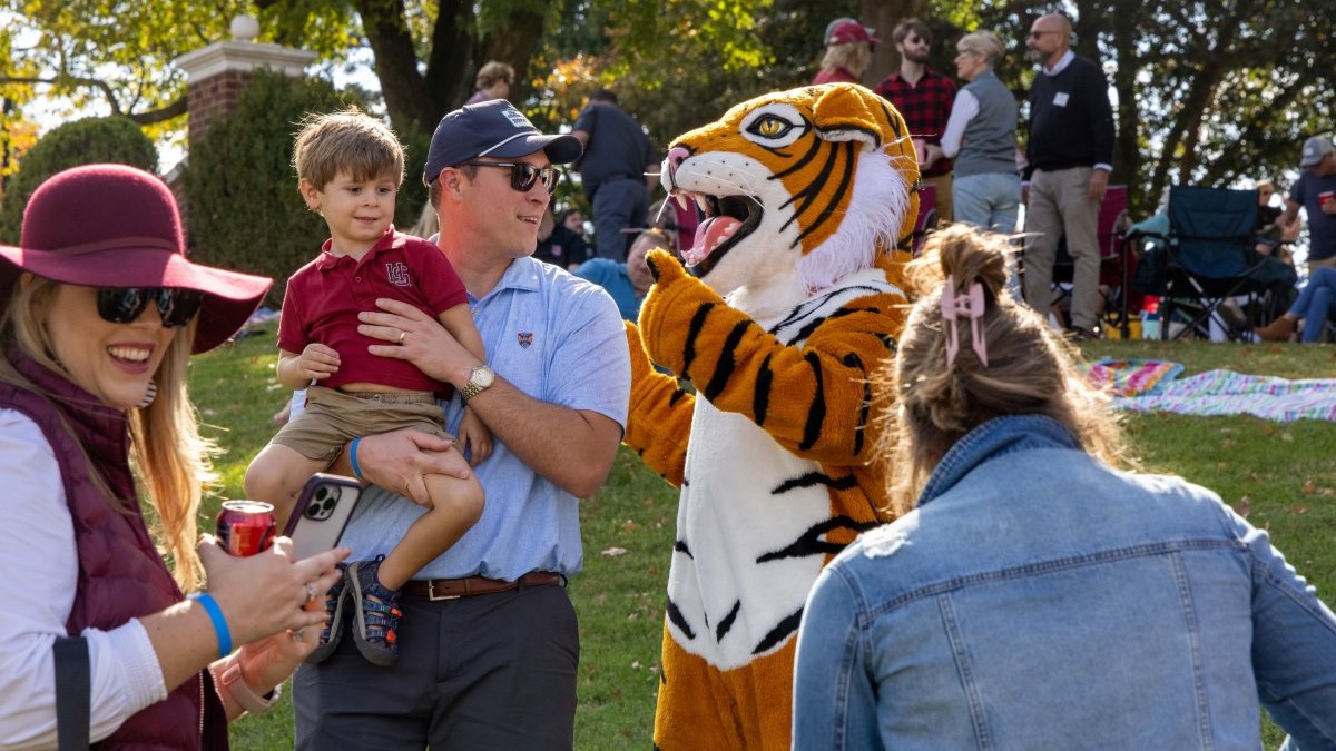 alumni family with the Hampden-Sydney Tiger at a football game