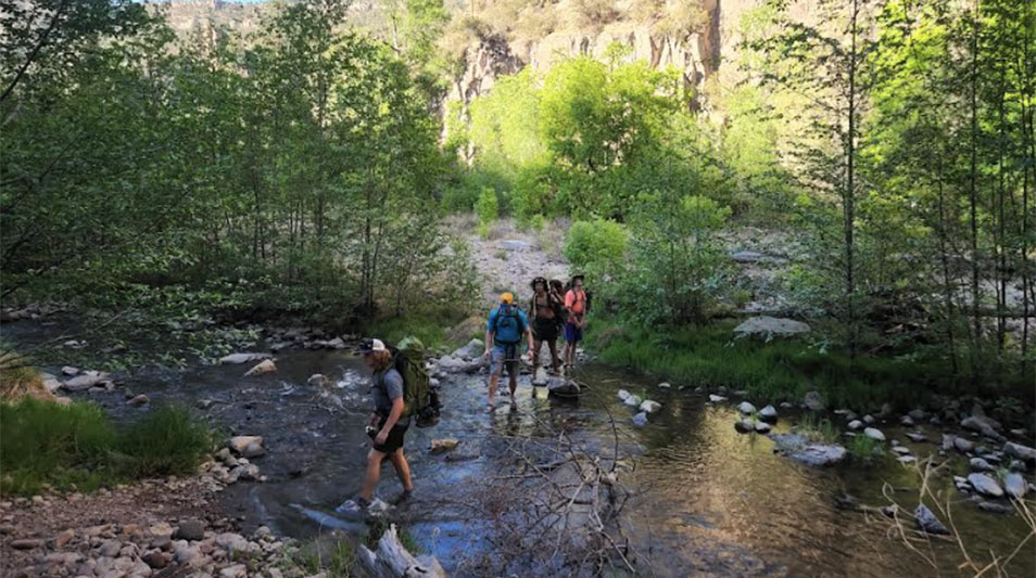 students walking through a stream in the Mexican Gila Wilderness 