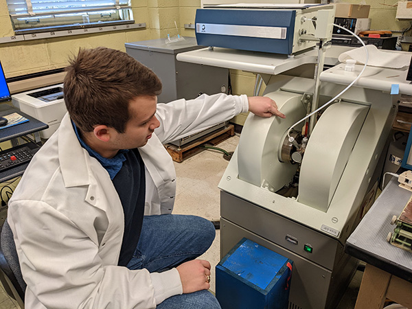 a student in a lab coat working in a biochemistry lab