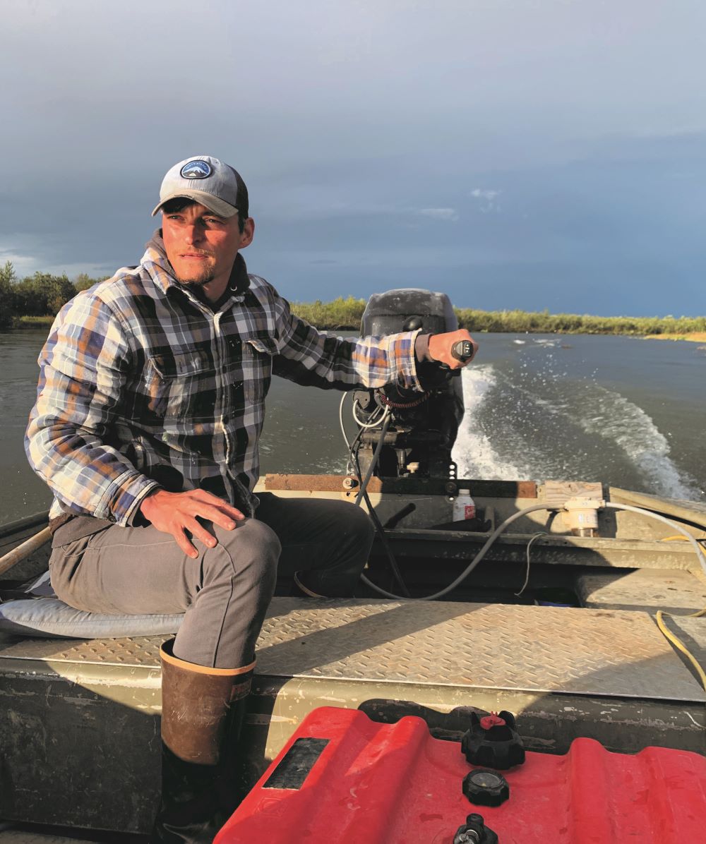 Professor manning a boat in Alaska