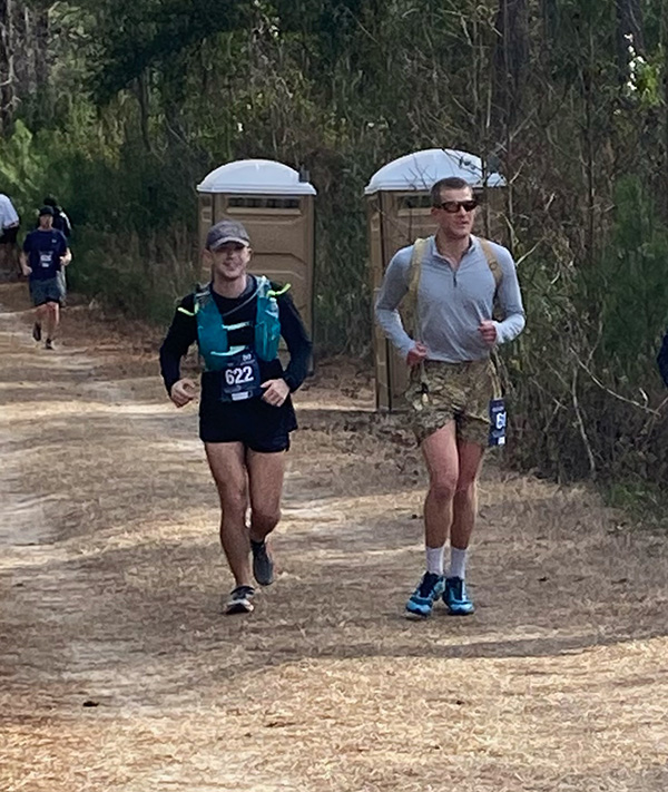 Carson Mann &rsquo;25, Greyson Hurley &rsquo;24, and James Gilbert &rsquo;23 running on a path during  an ultramarathon