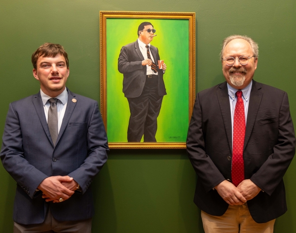 a portrait painting of John Brinkley in his typical stance with students and professor