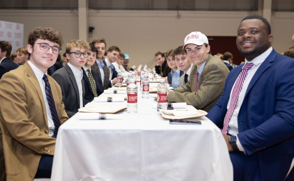 students sitting at a dinner table together