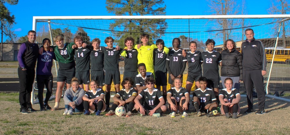 Hampden-Sydney student coaches posing with the Prince Edward  high school soccer team