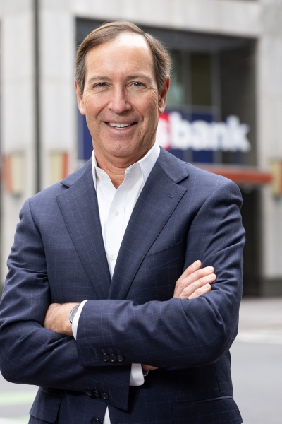 Dee O’Dell ’87 standing in front of a bank