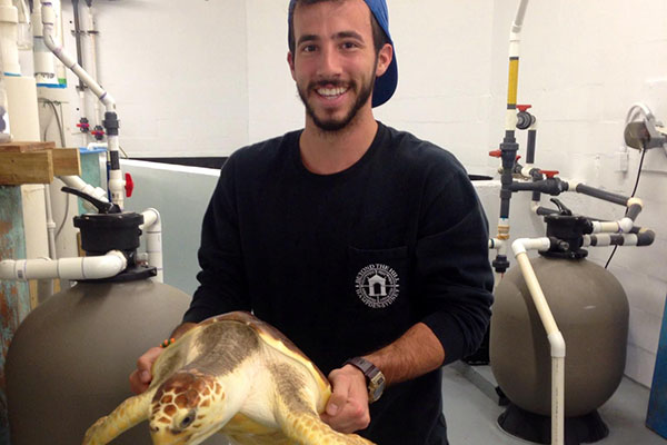 Nick DeProspero holding a sea turtle