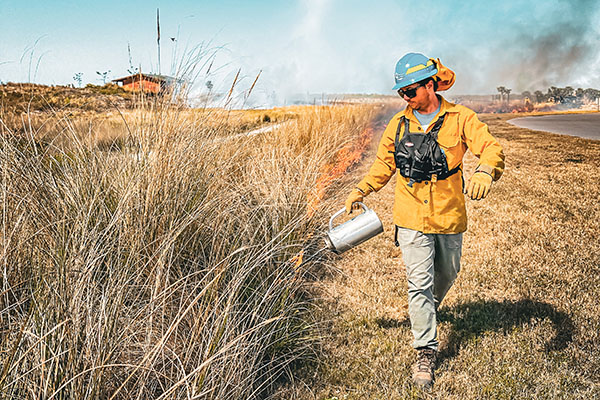 Shaun Swartz creating a prescribed burn blaze