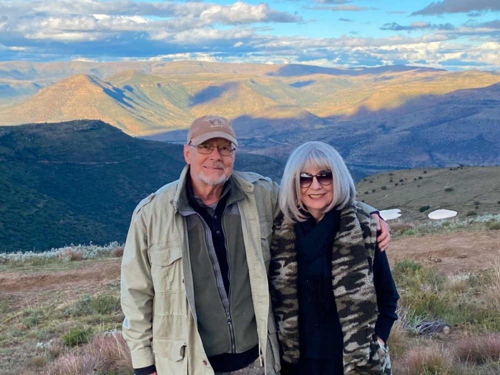 Pete Mowbray and his wife standing in front of a mountain range