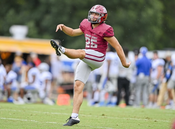 George Langhammer &rsquo;24 on the field kicking a football at a Tiger football game