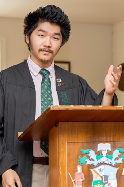 Ben Jia reading a book in the library