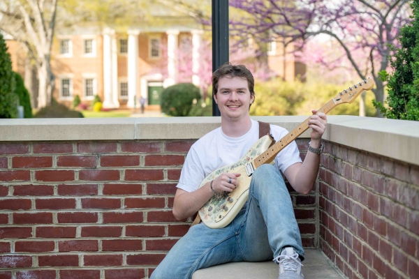 Scott Gipson &rsquo;26 playing a guitar