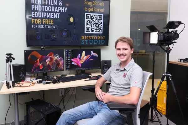 Haden VonCanon sitting at a Rhetoric Studio work station