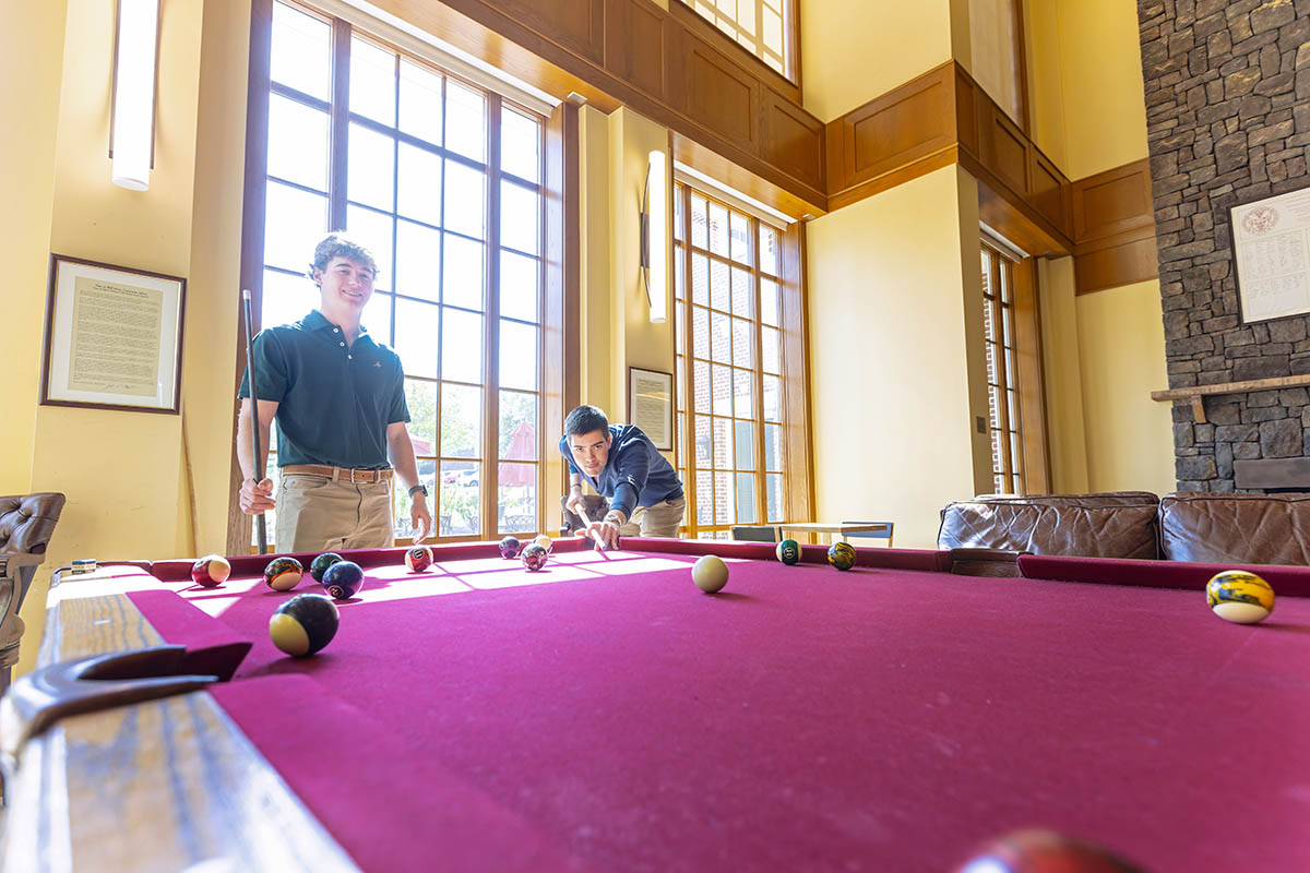students playing pool in the student center