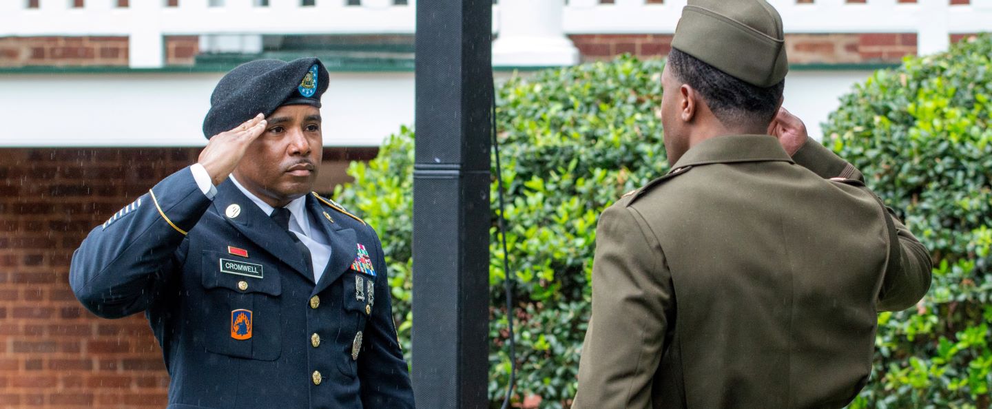 a student and an officer saluting